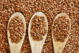 Buckwheat in wooden spoons
