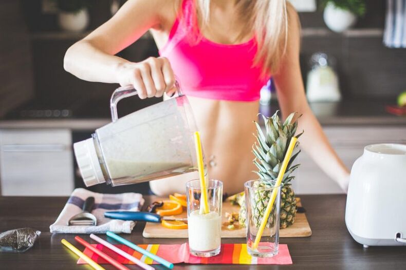 the girl prepares a shake to lose weight